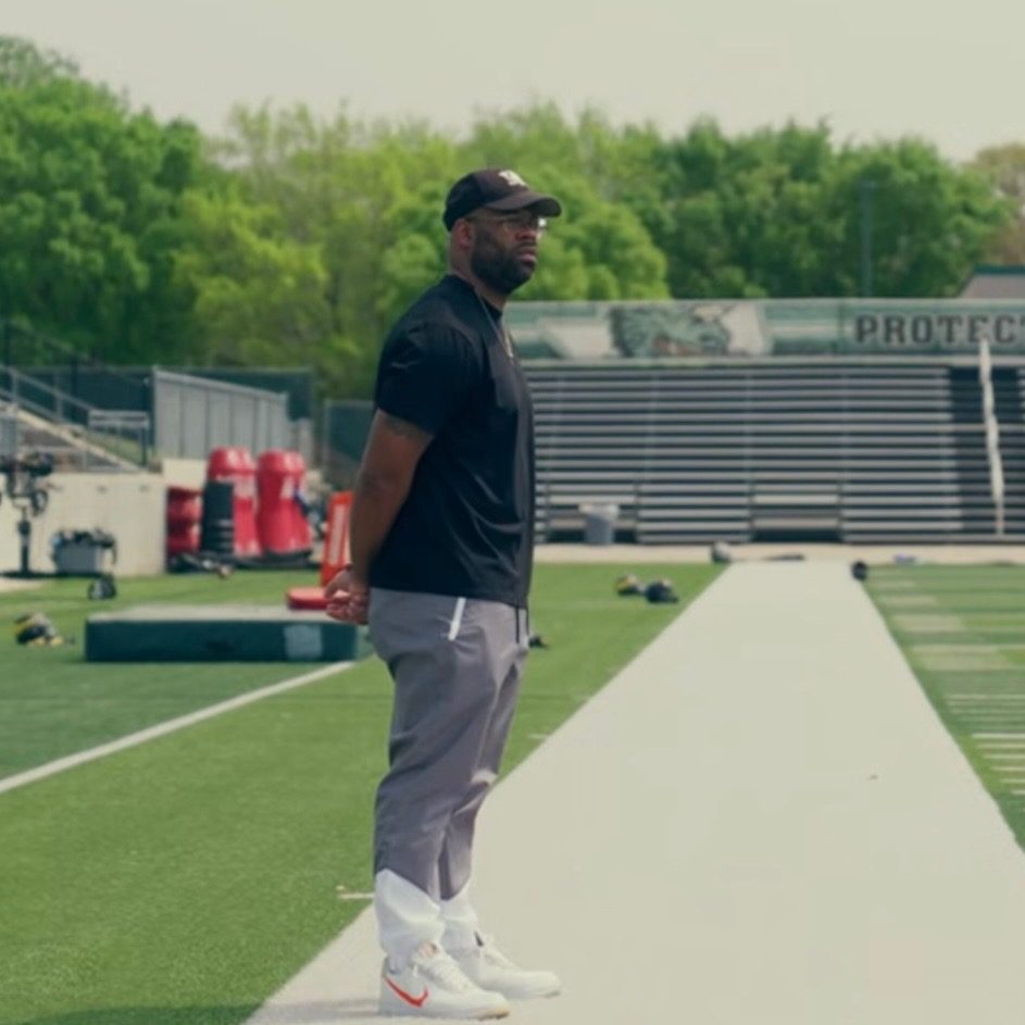 Markus Hawkins standing on a football field